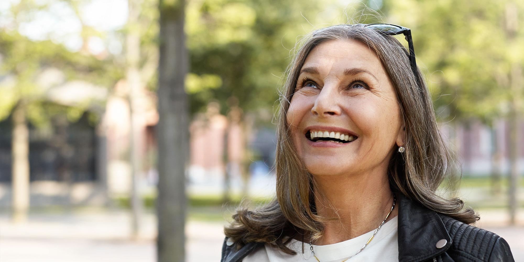 mature women smiling brightly outside